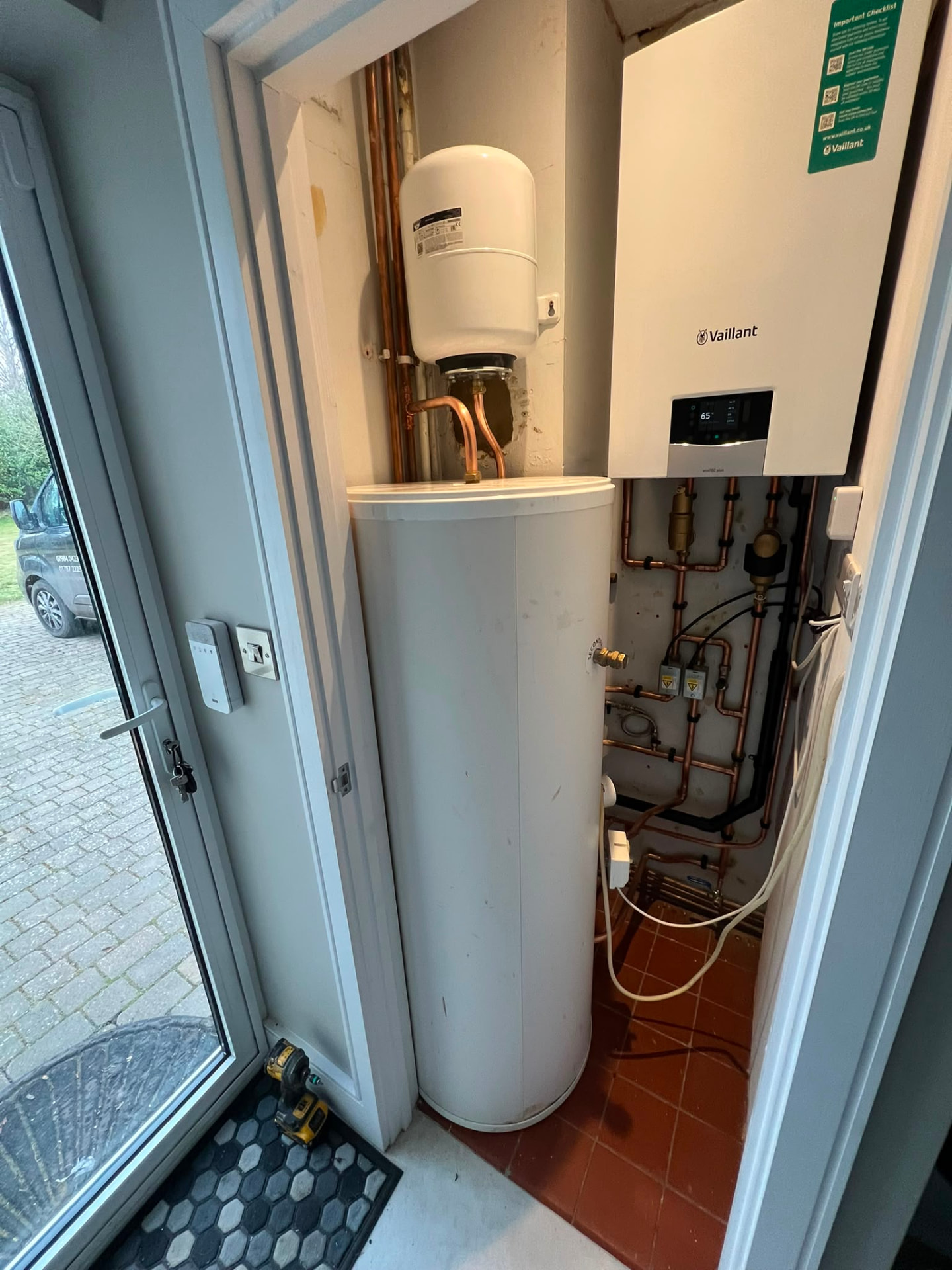 Vaillant system boiler and hot water cylinder installation in a utility cupboard, fitted by Gas Safe registered engineers in Essex