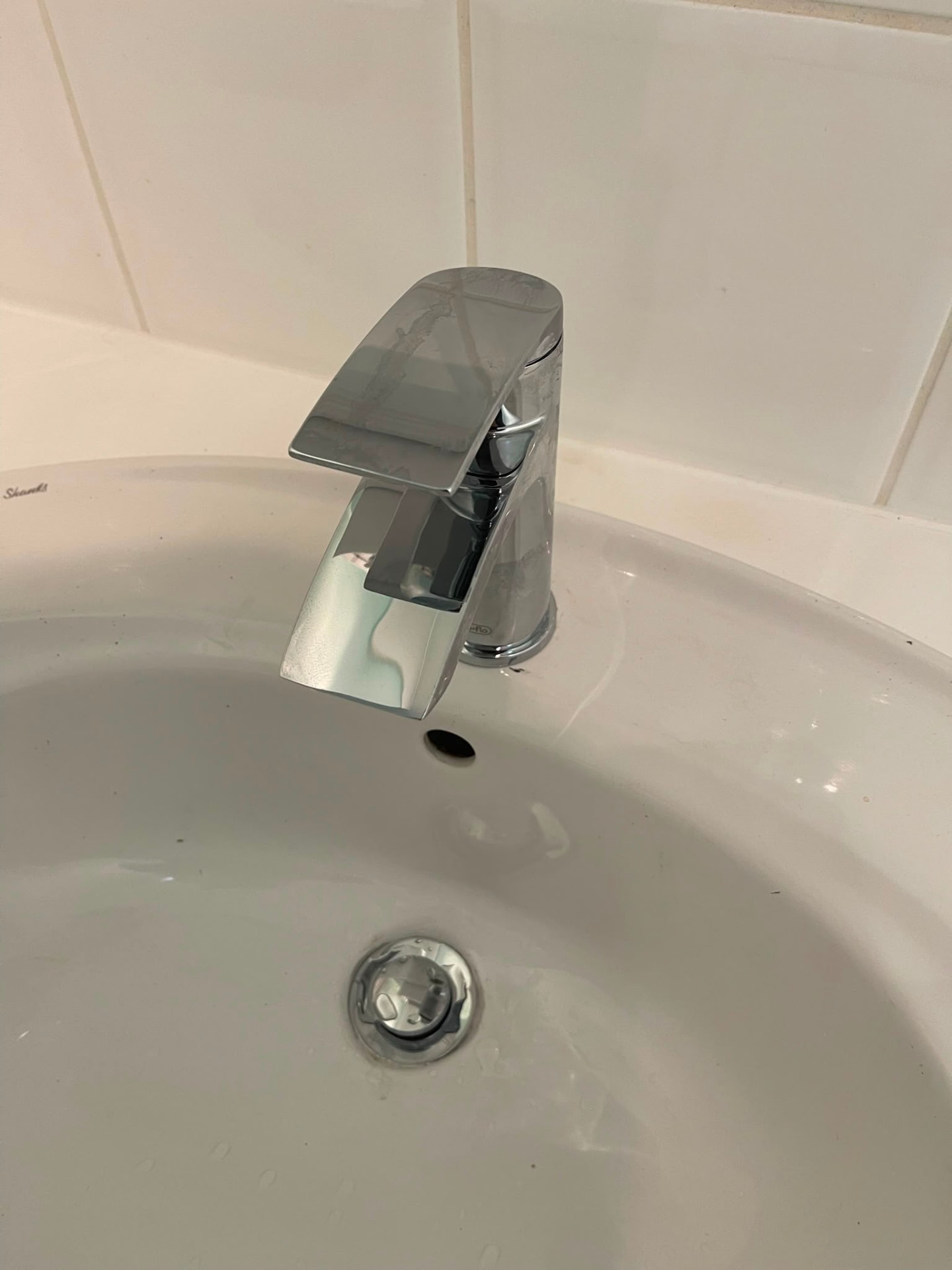 Chrome basin mixer tap installation on a white ceramic bathroom sink, fitted by Gas Safe registered engineers in Essex