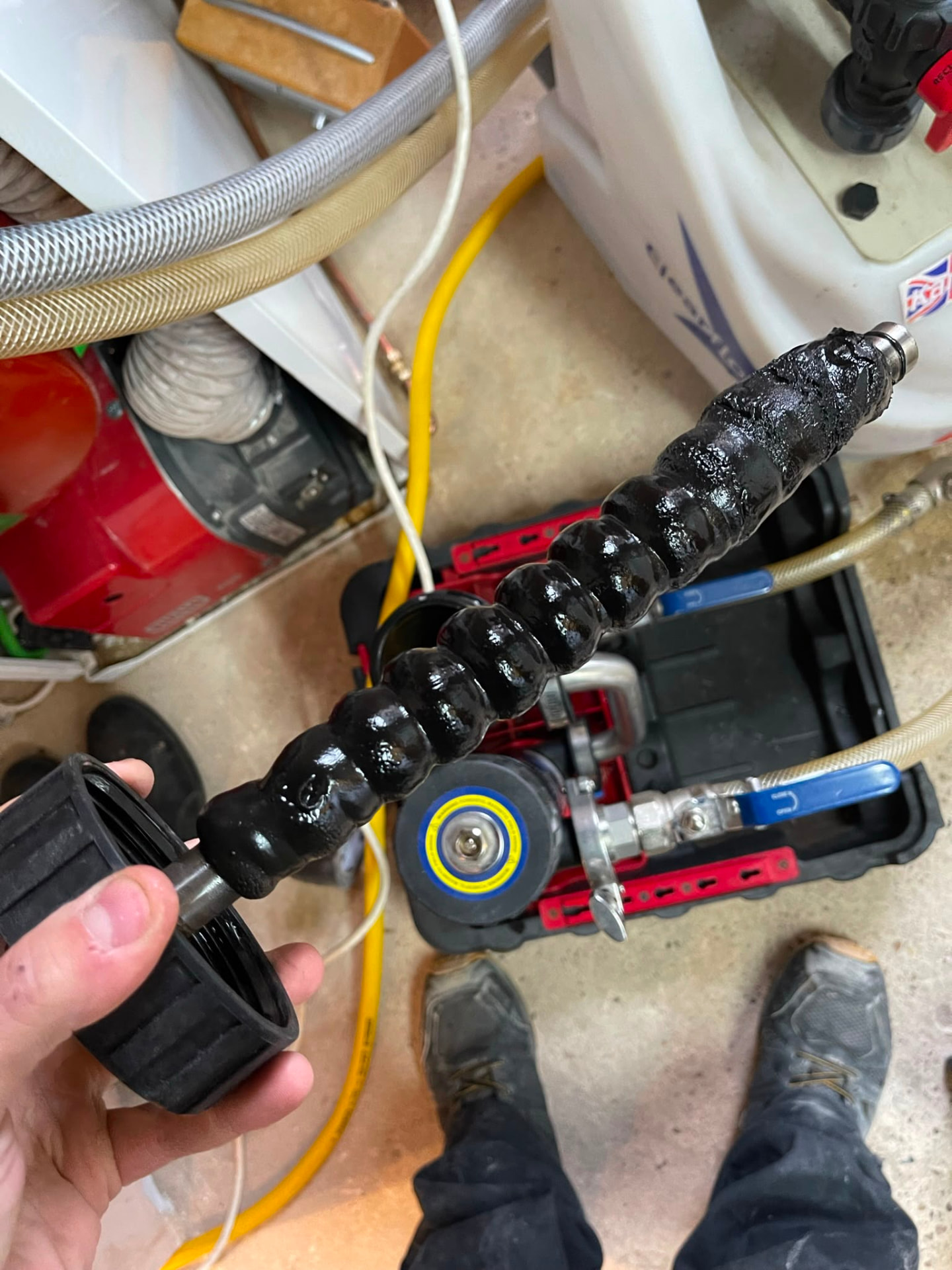 Magnetic filter rod covered in black iron oxide sludge removed during a central heating powerflush, fitted by Gas Safe registered engineers in Essex